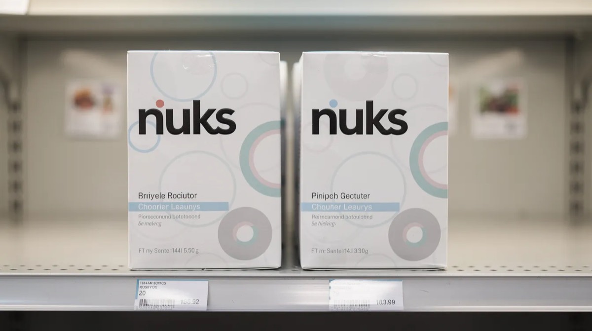 Two similar product packages on a shelf